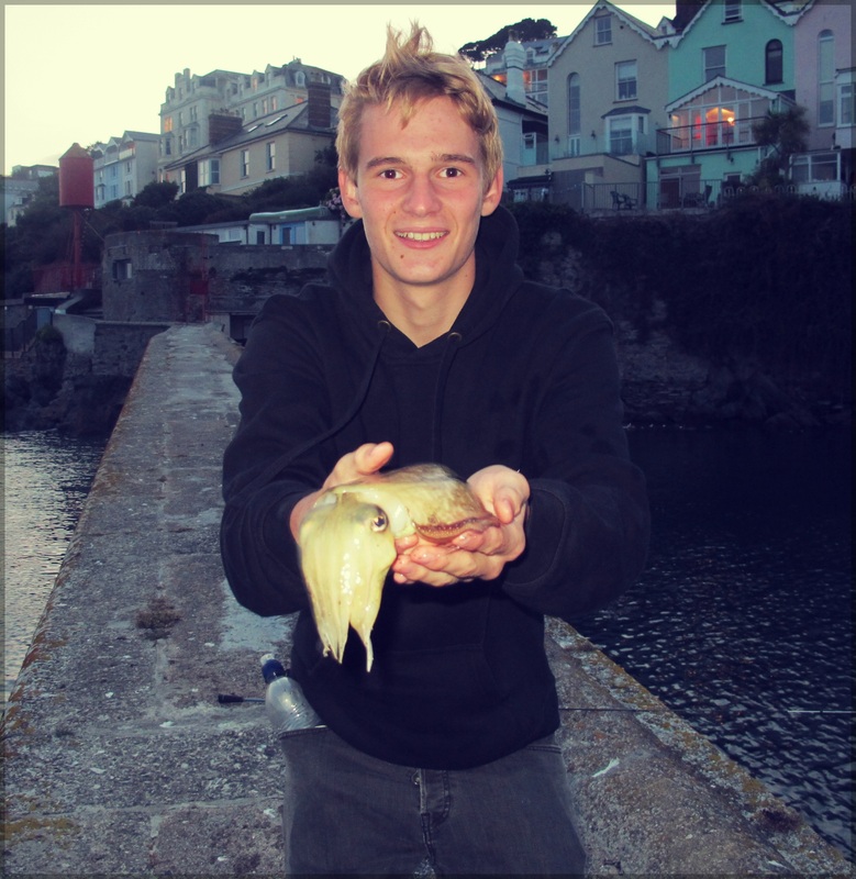 a cuttlefish being held by a boy