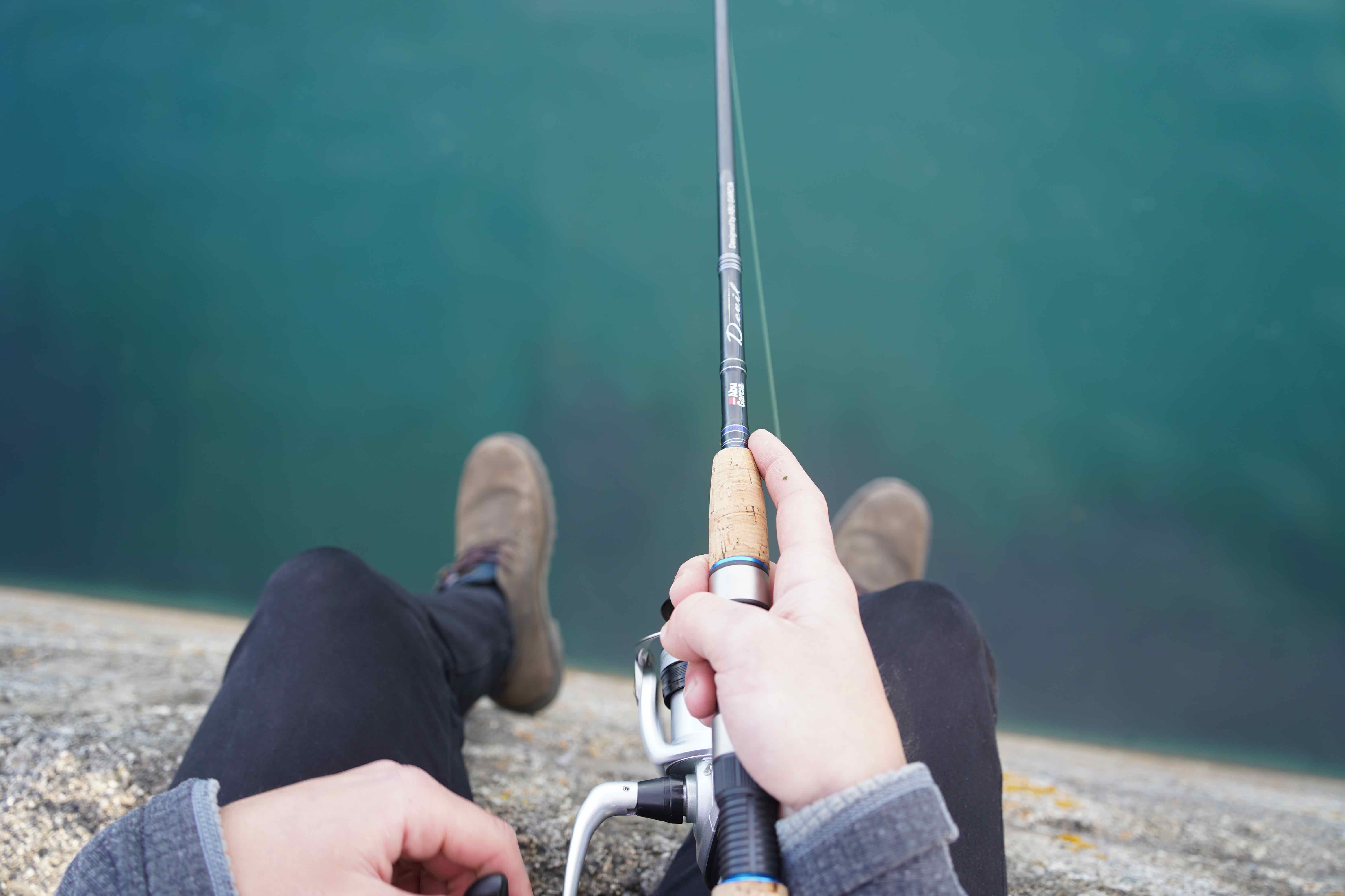 lure fishing from a pier wall