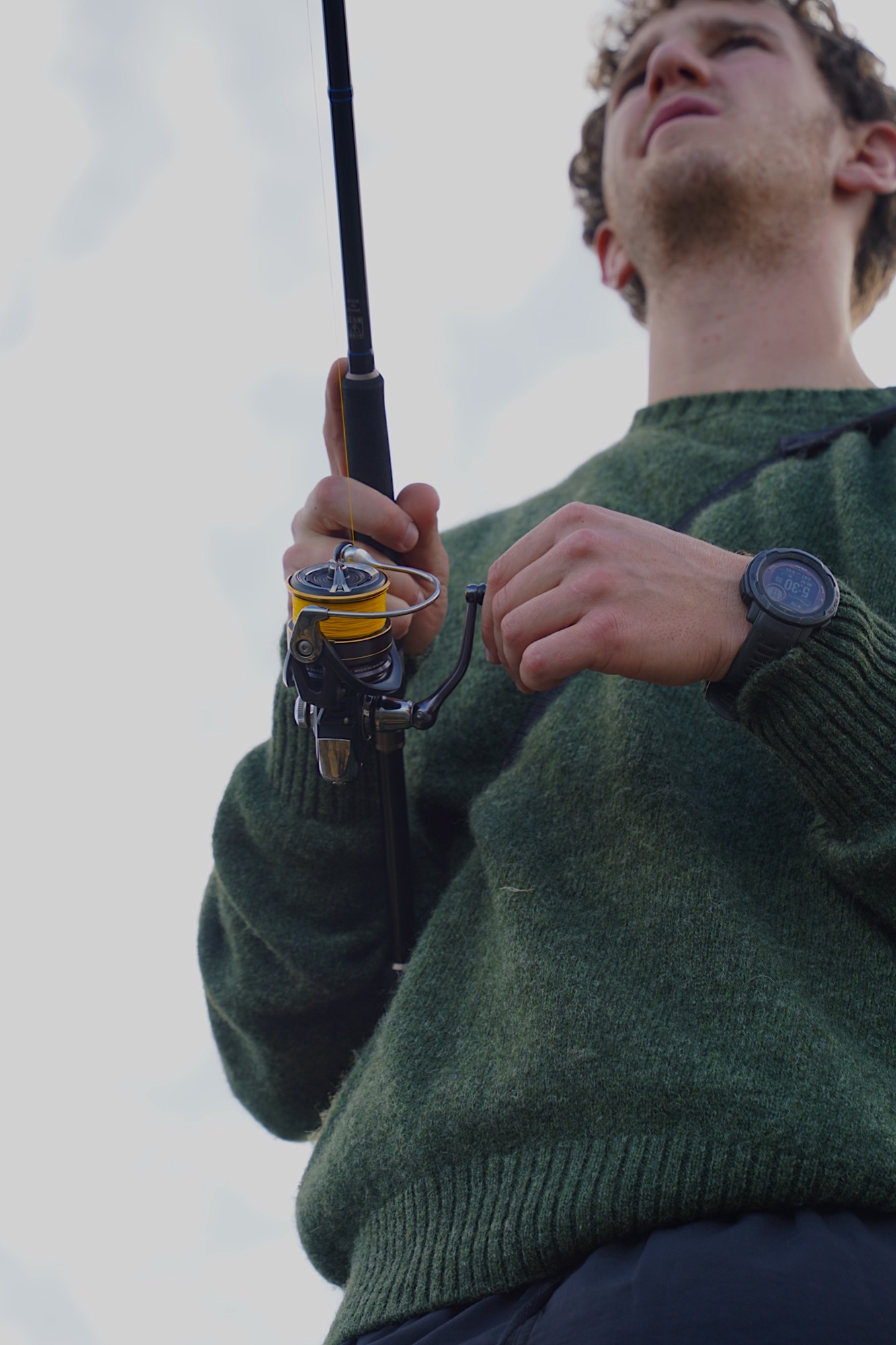 an angler rock fishing retrieving a lure