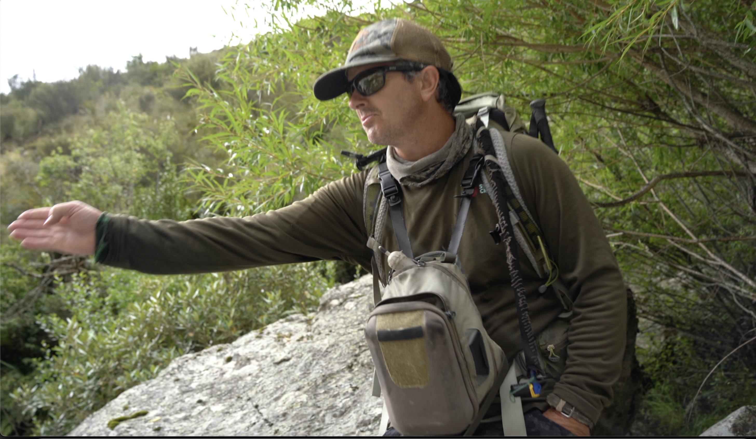 trout guide spots a trout in the river