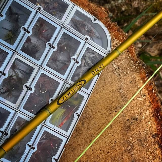 vision fly rod next to trout flies